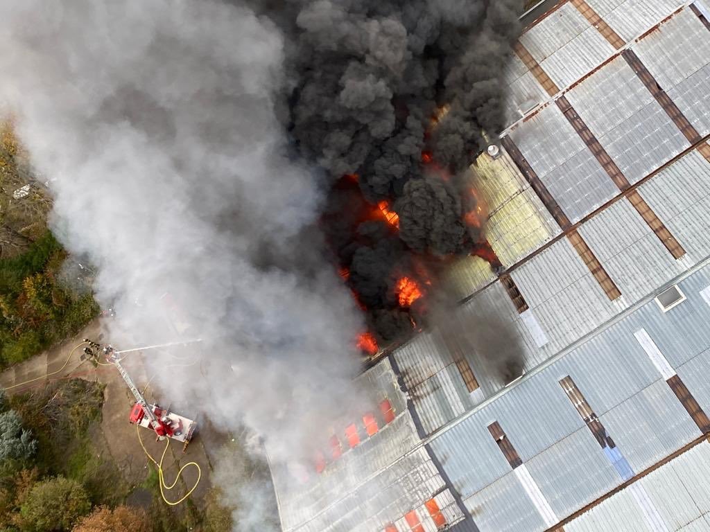 A large amount of black smoke emerges from the fire in an abandoned warehouse in Le Havre France