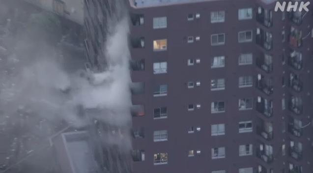 Smoke billows in a fire in a high-rise apartment in Tokyo, Japan