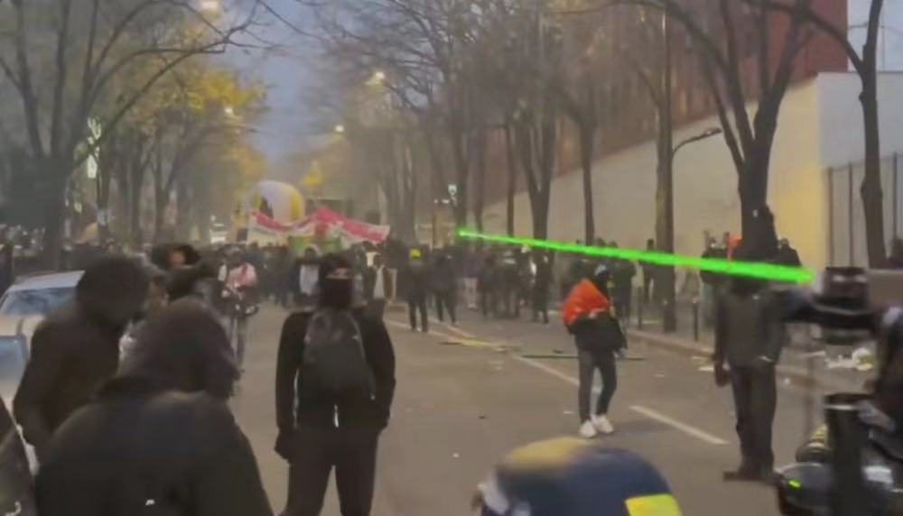 Paris demonstrators smashed shops, burned cars, and shot laser pointers indiscriminately. Police arrested 22 people.