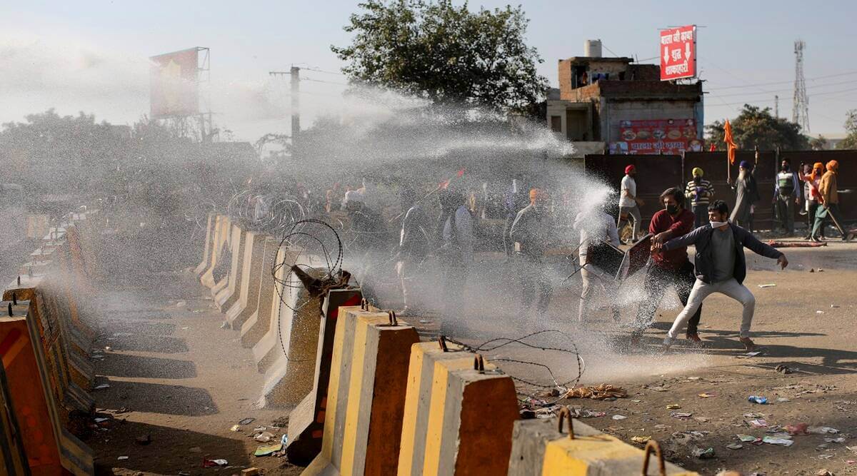 Indian farmers drove tractors to break through roadblocks. Police fired tear gas to intercept them.