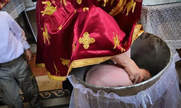 Romanian priest soaked the baby in water and killed him. People called for a change in the ceremony.