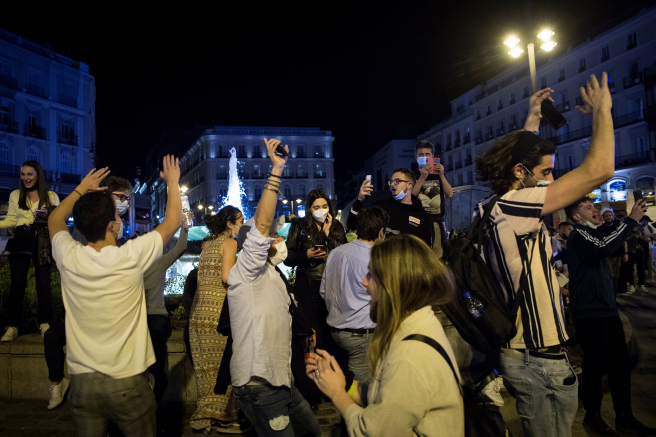 Spain's national emergency ends as people gather in many places to celebrate the increased threat of spreading the disease